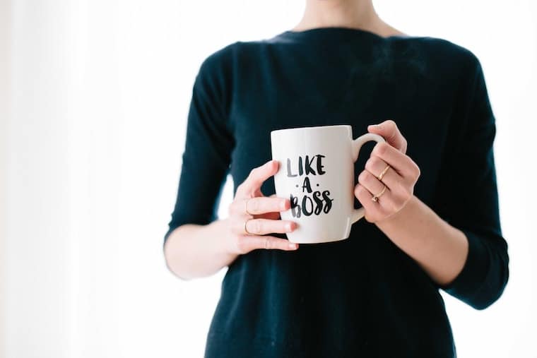 Woman holding a mug that says: Like a Boss. 