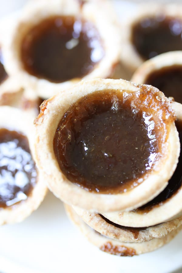 close up of vegan butter tarts stacked on top of each other 