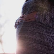 A woman holding her pregnancy bump.