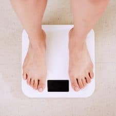 Woman standing on a scale.