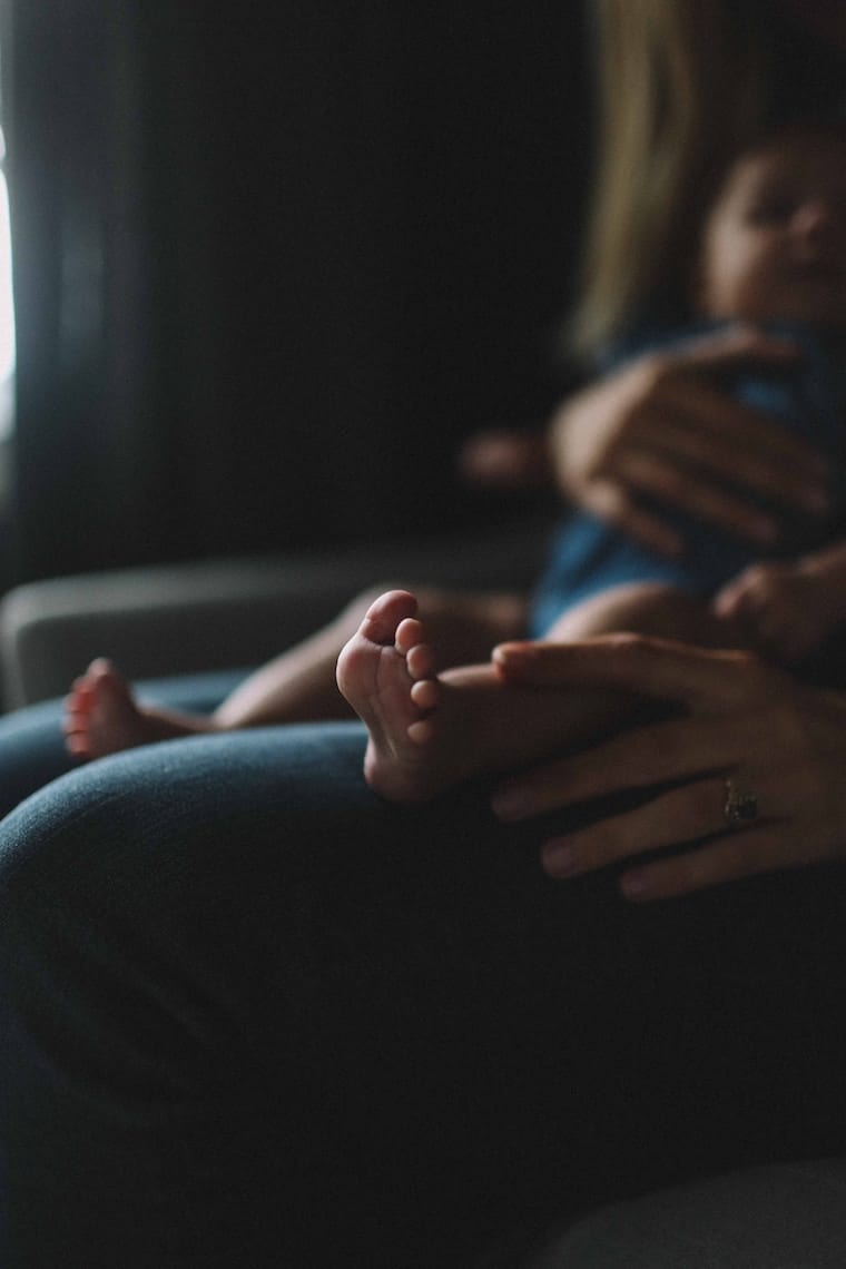 Mom holding her baby on her lap. 