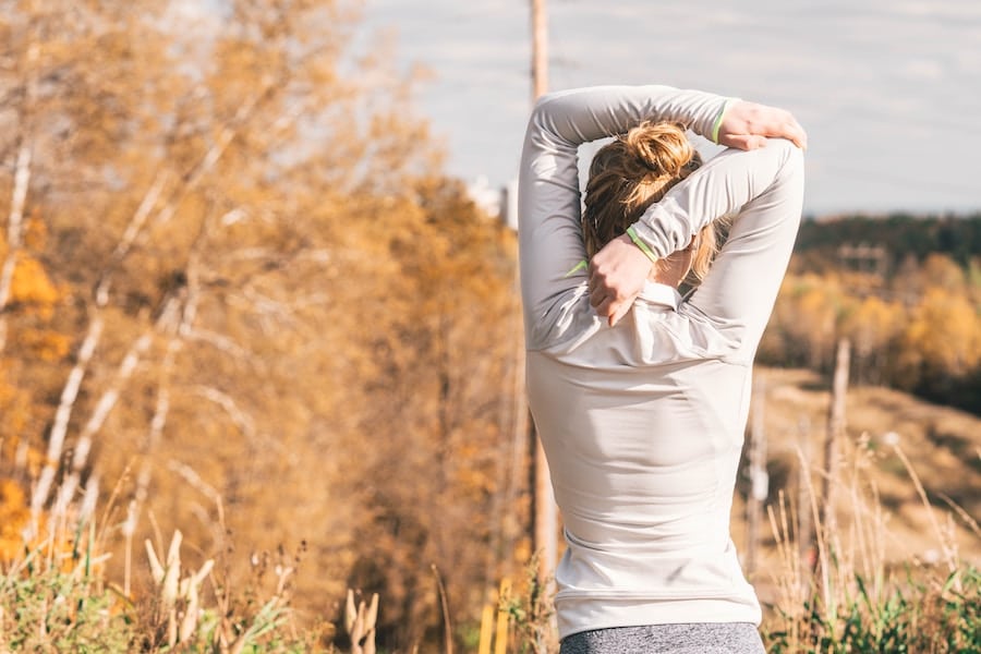 Woman stretching outside.