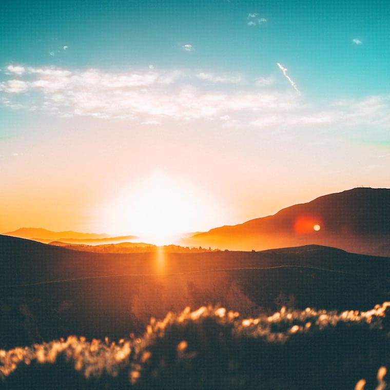 a sunset in a field