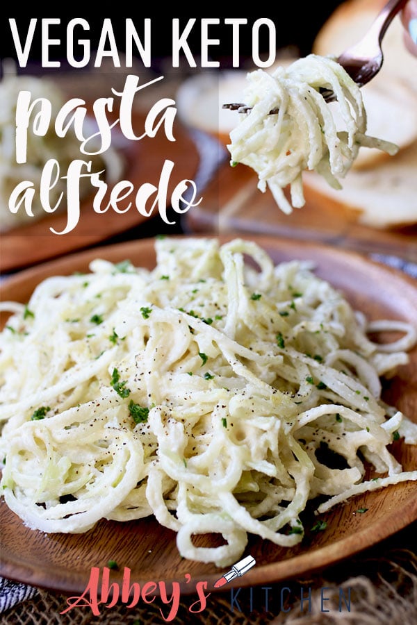 pinterest image of vegan keto pasta alfredo topped with herbs on a wooden plate