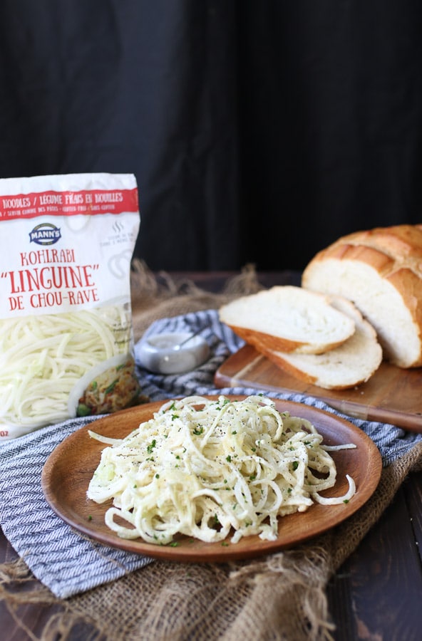 keto pasta recipe on a wooden plate with bread in the background