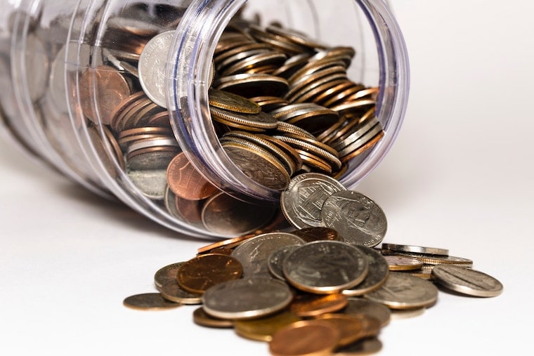 clear jar with coins spilling out