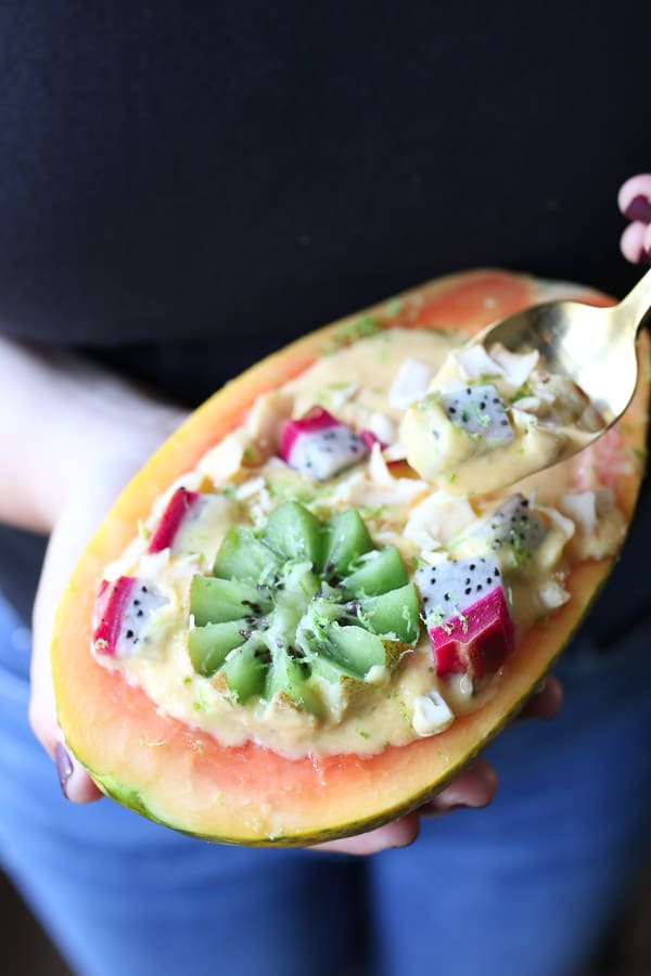 This Vegan Tropical Mango Smoothie Bowl in an Edible Papaya Bowl is a healthy summer breakfast for busy days.