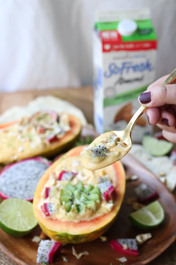 This Vegan Tropical Mango Smoothie Bowl in an Edible Papaya Bowl is a healthy summer breakfast for busy days.
