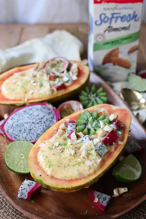 This Vegan Tropical Mango Smoothie Bowl in an Edible Papaya Bowl is a healthy summer breakfast for busy days.