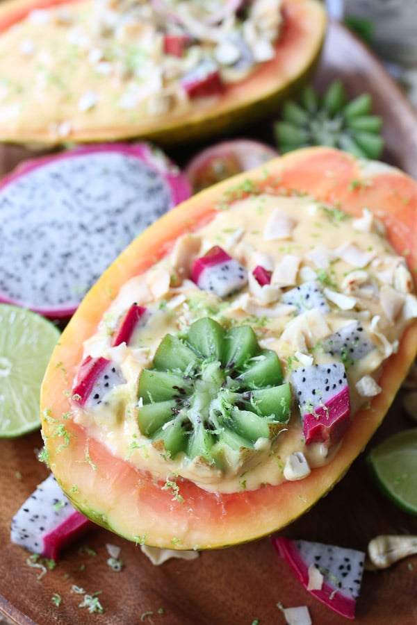 This Vegan Tropical Mango Smoothie Bowl in an Edible Papaya Bowl is a healthy summer breakfast for busy days.