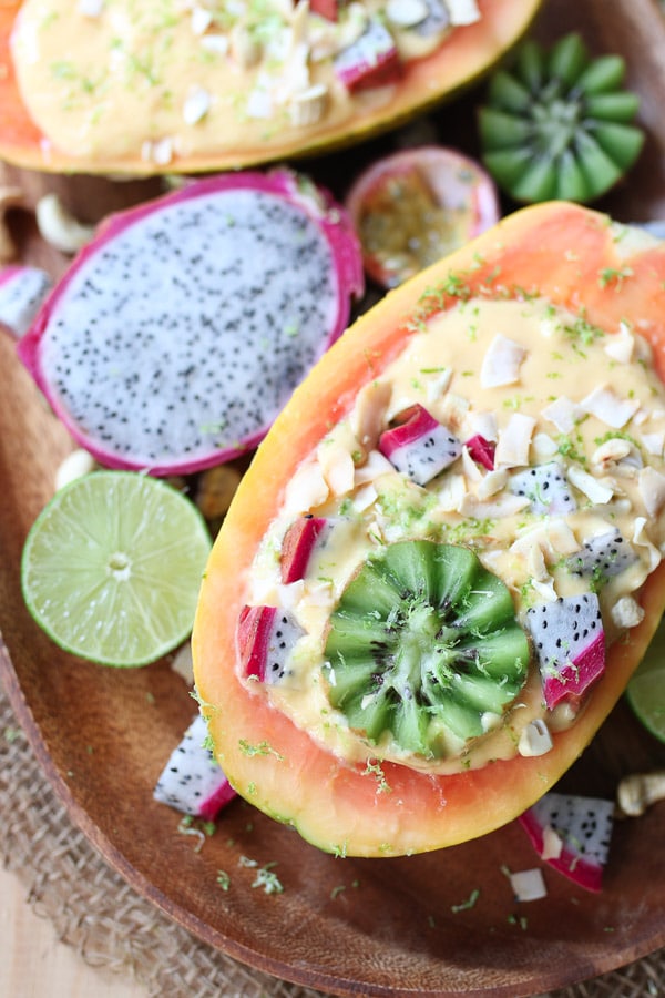 This Vegan Tropical Mango Smoothie Bowl in an Edible Papaya Bowl is a healthy summer breakfast for busy days.