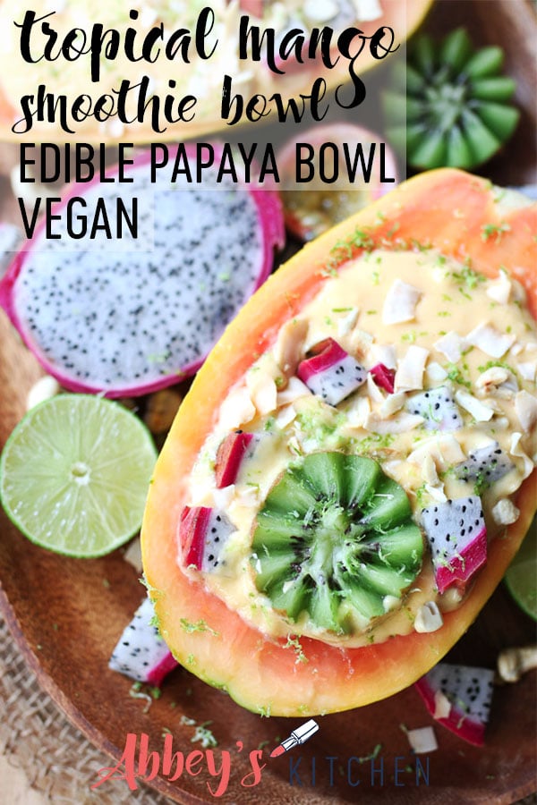 Vegan Tropical Mango Smoothie Bowl in an Edible Papaya Bowl #summer #smoothiebowl #breakfast #healthystart #healthyeats #papaya #tropicalfruit #kiwi #veganeats #veganbreakfast