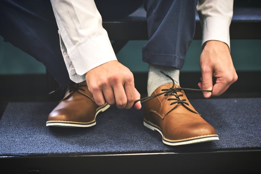 Person tying their shoelace.