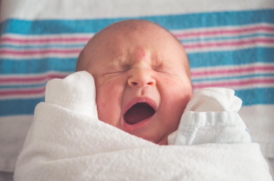 A baby yawning.