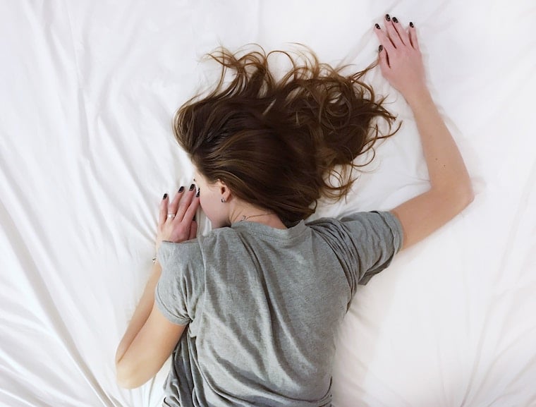 Women lying on her bed. 