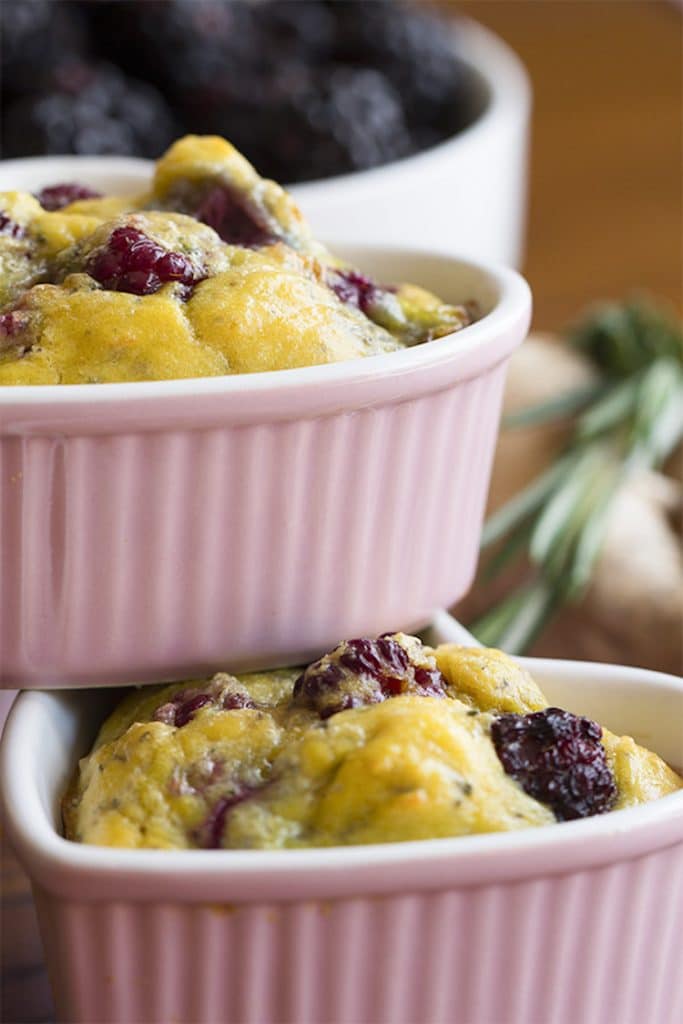 close up of small pink ramekins containing keto blackberry egg cakes