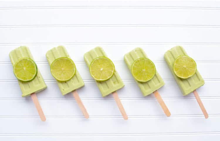 line up of keto lime creamsicles on a white background