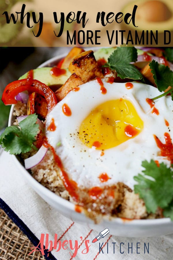 close up image of a fried egg on top of vegetables in a white bowl