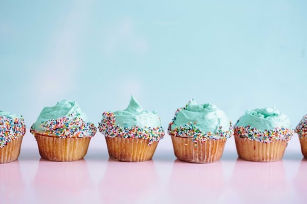 colourful cupcakes against a blue and pink background