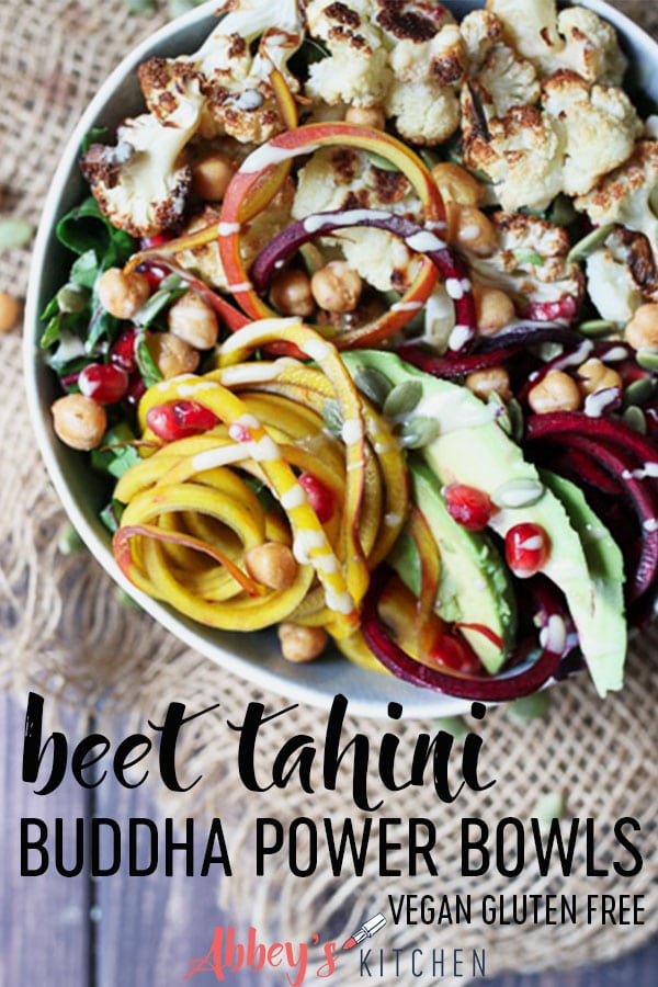 pinterest image of vegan tahini beet buddha bowl garnished with pomegranate seeds with text overlay