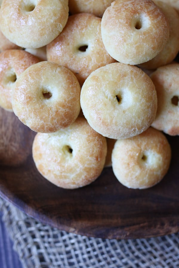 Mini keto bagels on a wooden plate.