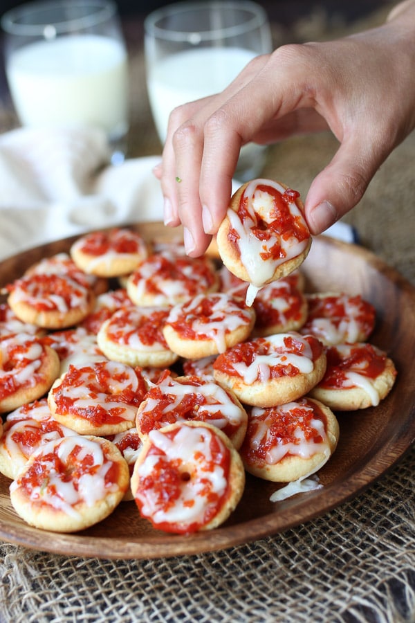 Hand holding a homemade bagel bite.