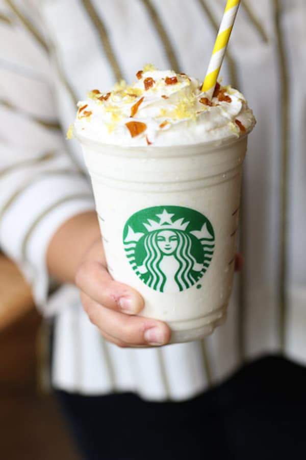 Hand holding lemon bar frappuccino.