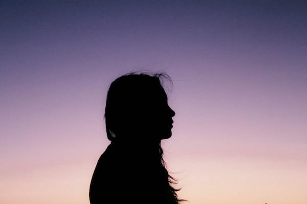 silhouette of a person against a sunset