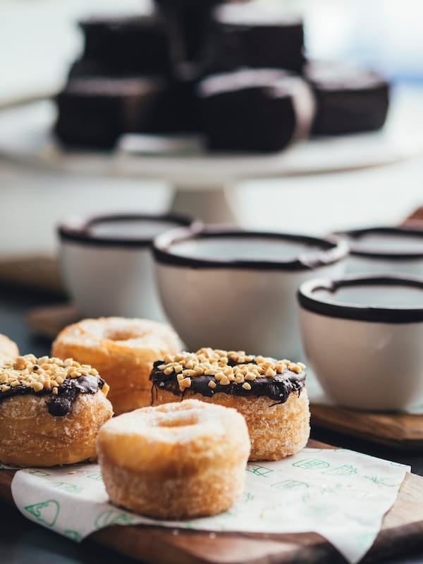 Plate of donuts next to coffee