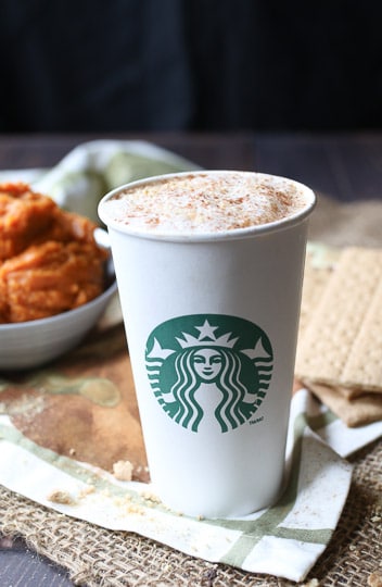 Pumpkin latte in a starbucks cup.