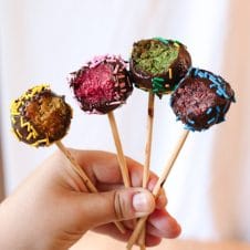 These Vegan Rainbow Cake Pops are delicious gluten free healthy treats for kids and adults alike that can be made in a rainbow of colours and decorated with little sprinkles and candies!