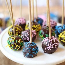 These Vegan Rainbow Cake Pops are delicious gluten free healthy treats for kids and adults alike that can be made in a rainbow of colours and decorated with little sprinkles and candies!