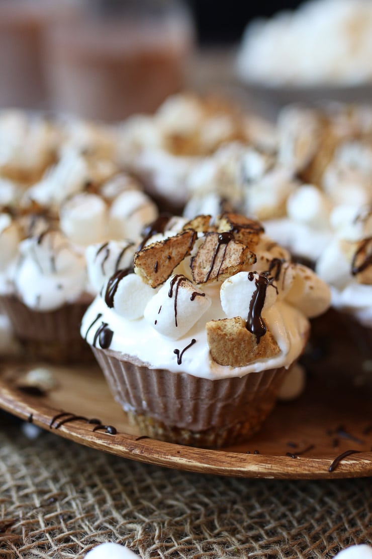 S'mores cupcakes on a wooden plate.