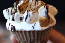 Hand holding a s'mores cupcake.