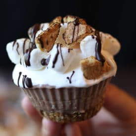 Hand holding a s'mores cupcake.