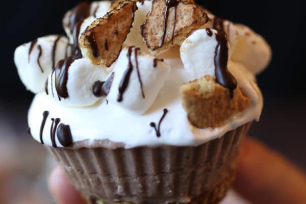 Hand holding a s'mores cupcake.