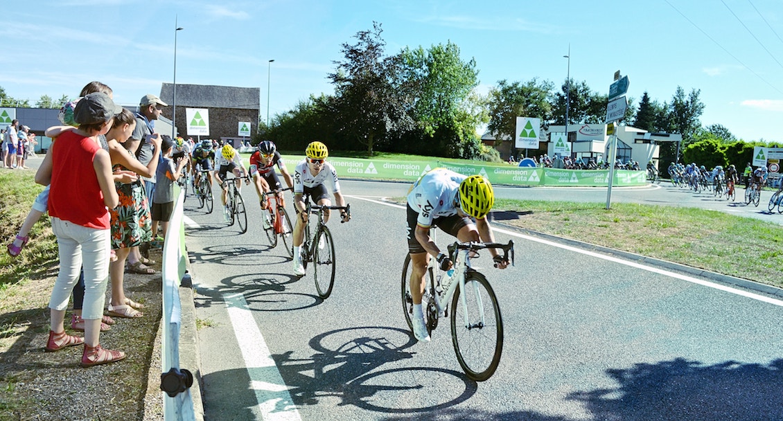 Cyclists racing on a road while intermittent fasting and working out. 