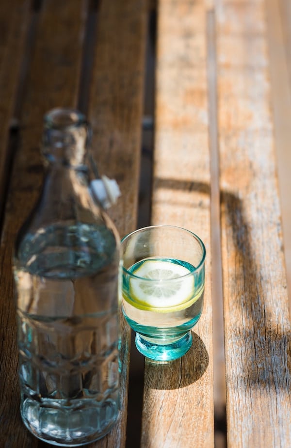 Cup filled with water and lemon slice