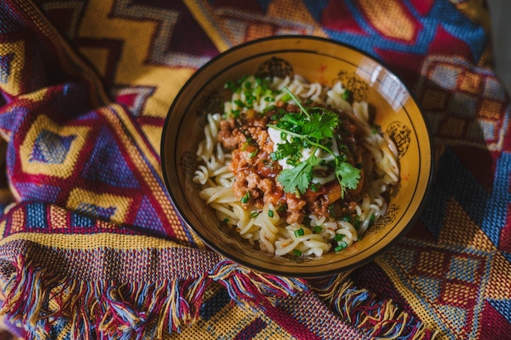 Bowl of pasta with tomato sauce.