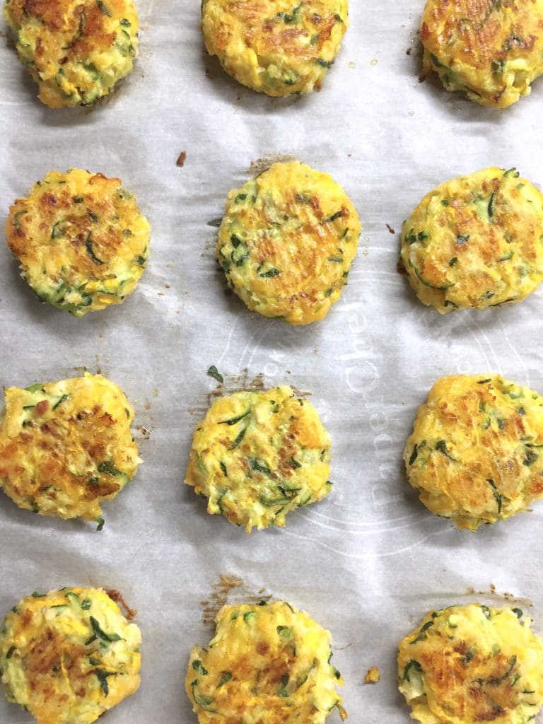 zucchini patties on parchment paper.