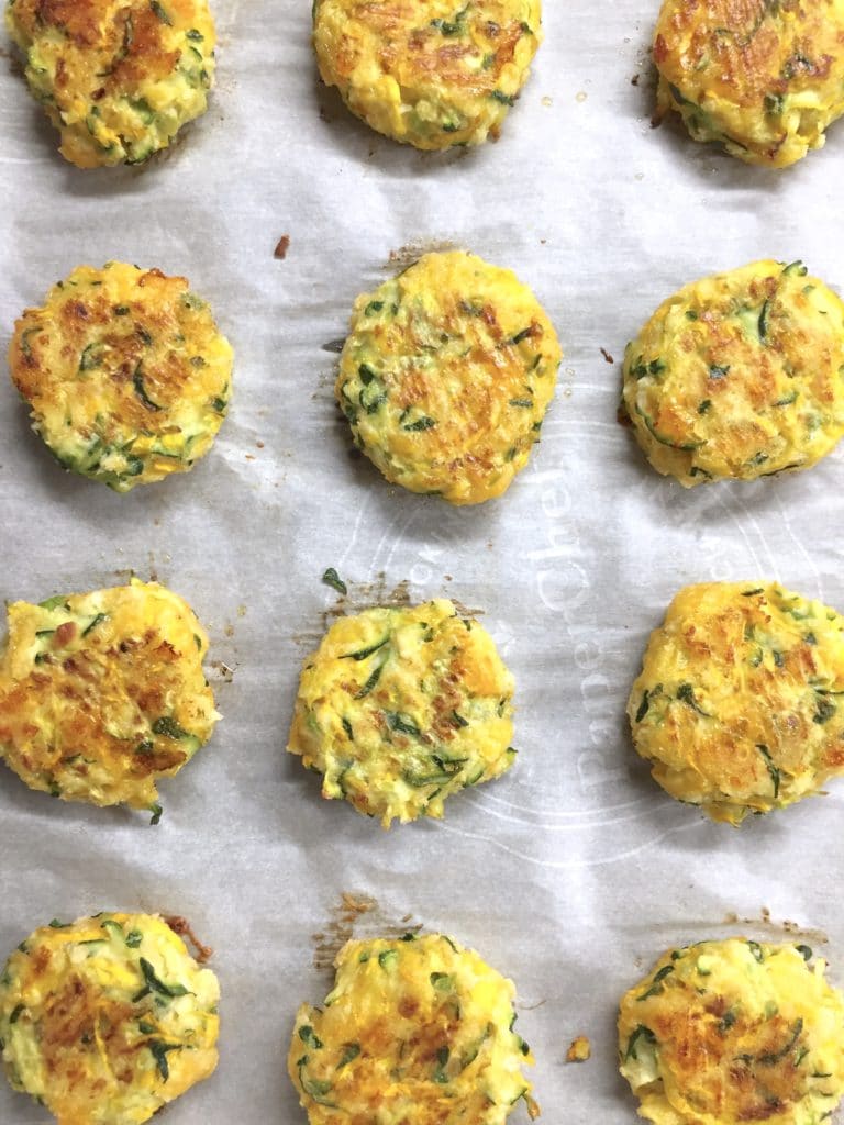 zucchini patties on parchment paper. 