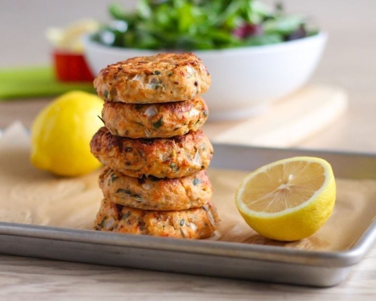 stack of gluten free lemon and herb salmon cakes on sheet pan 