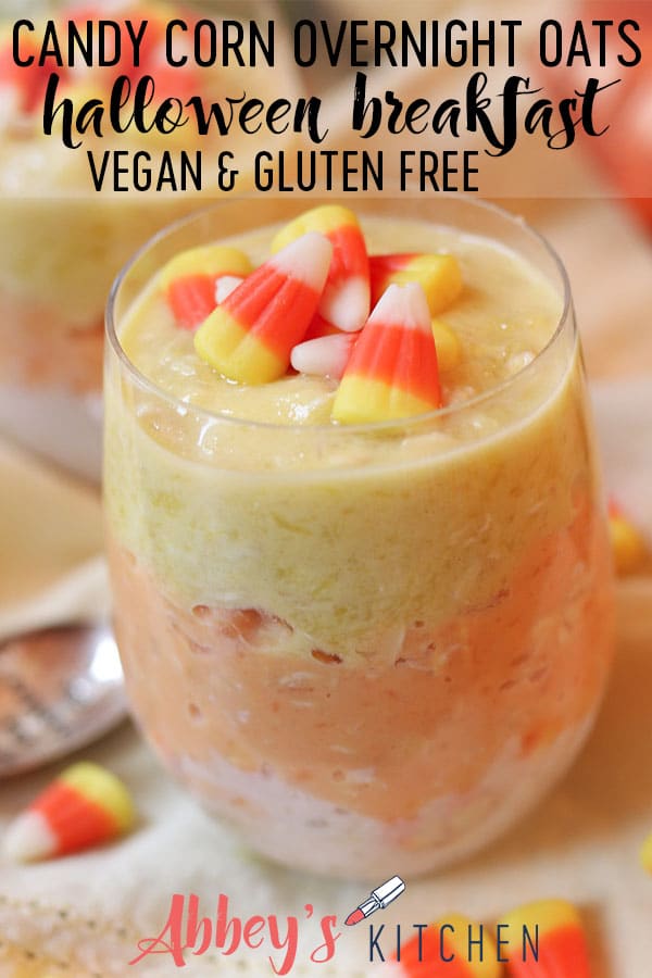 Pinterest image of vegan candy corn overnight oats for halloween in a clear glass topped with candy corn with text overlay