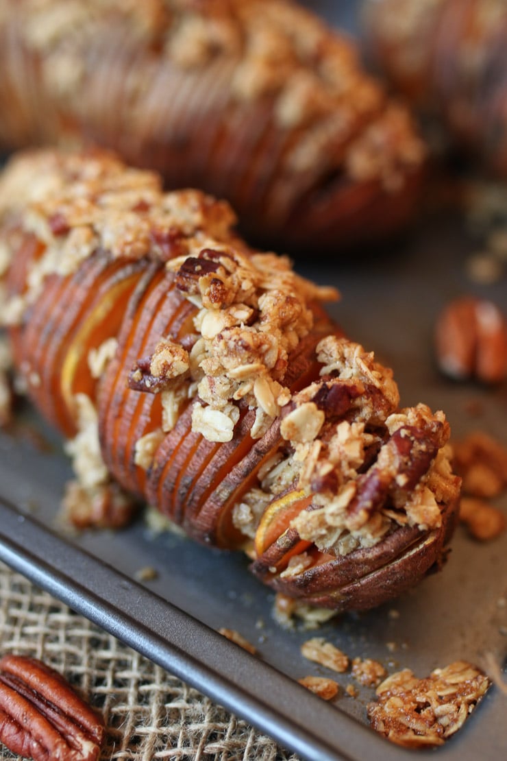 Close up of hasselback sweet potatoes on a sheet pan.