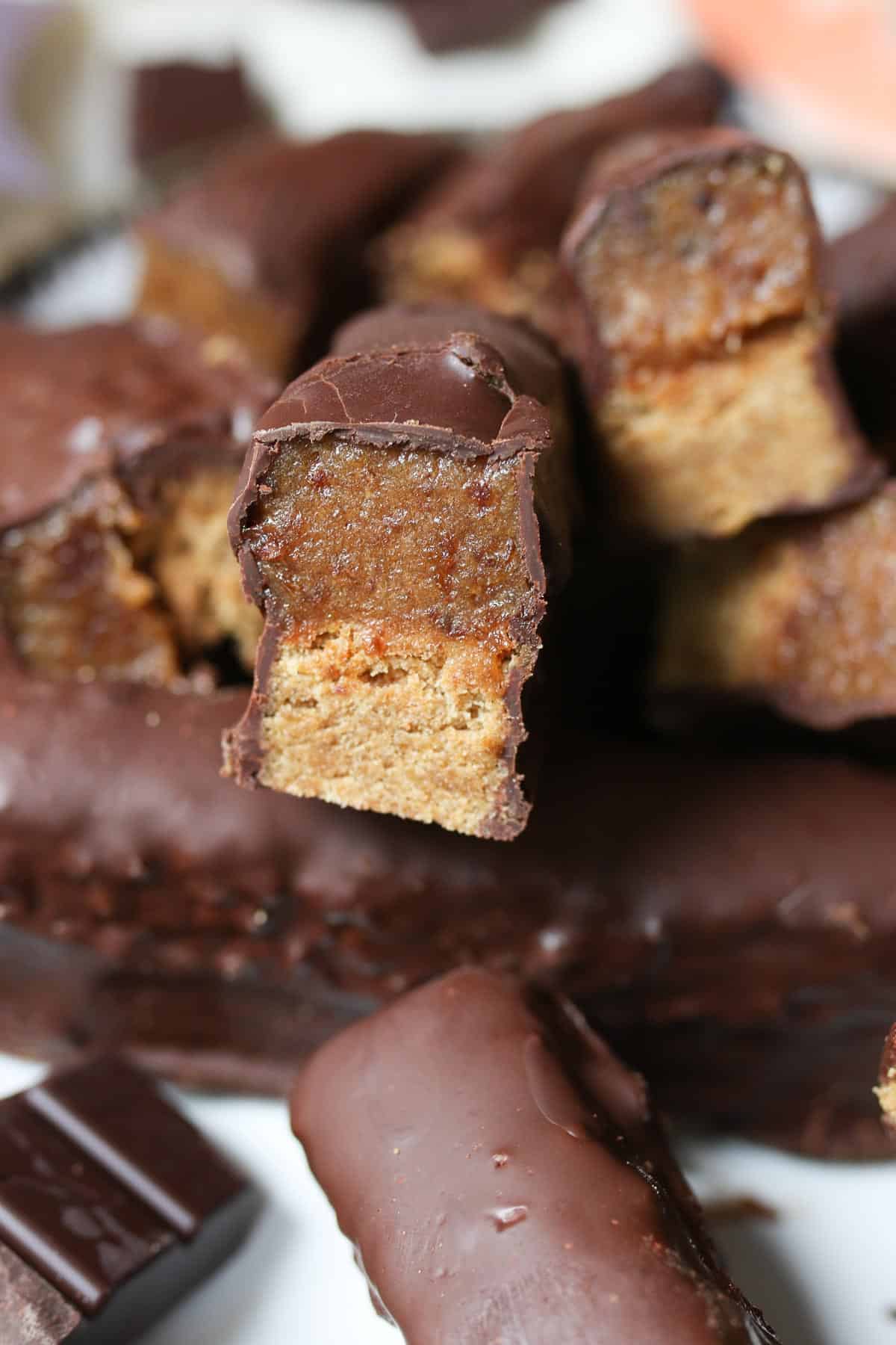 Several homemade Twix chocolate bars stacked on top of one another.