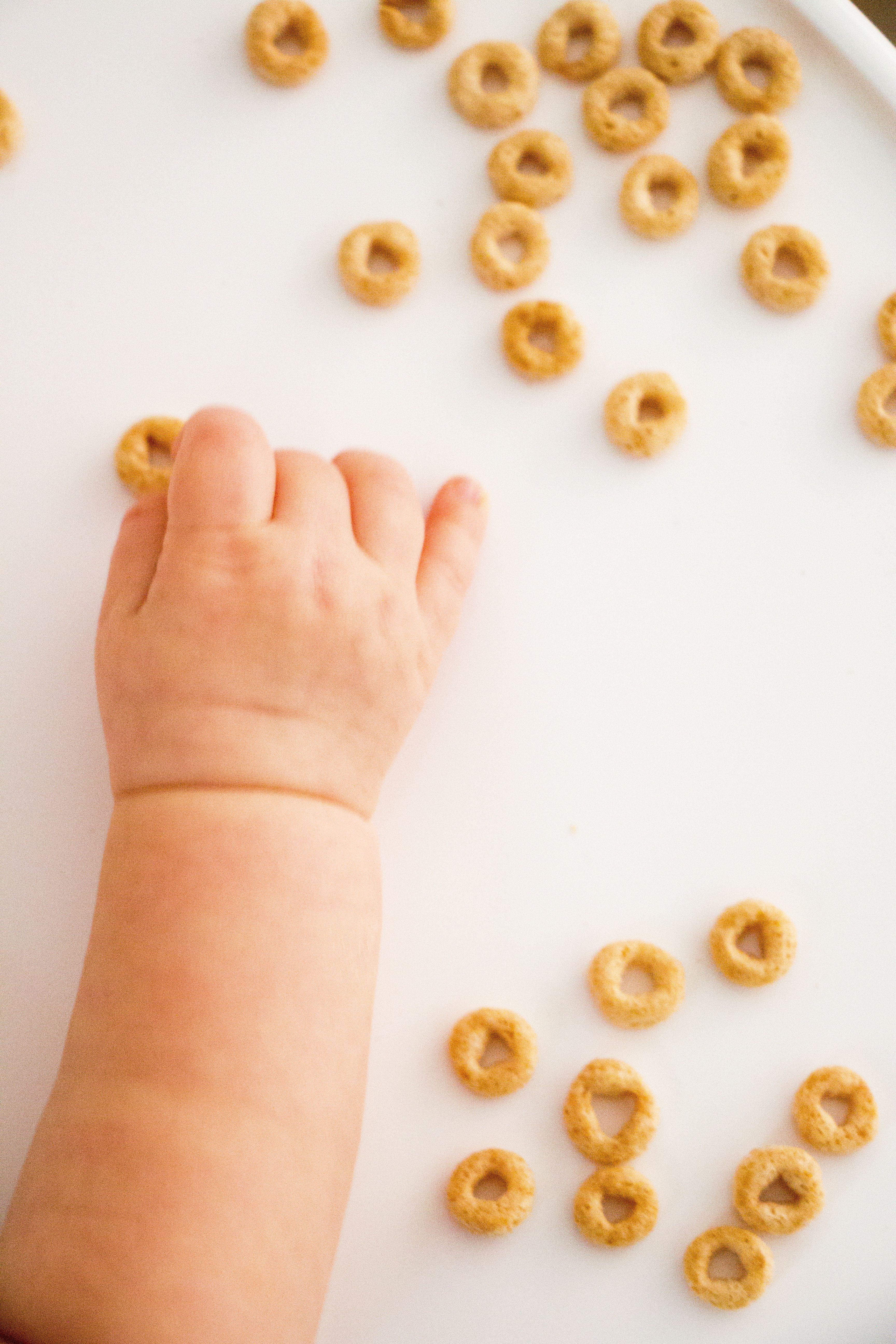 Baby grabbing cereal.