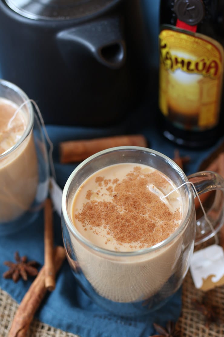 dirty Chai cocktail in a glass mug topped with cinnamon sprinkle 
