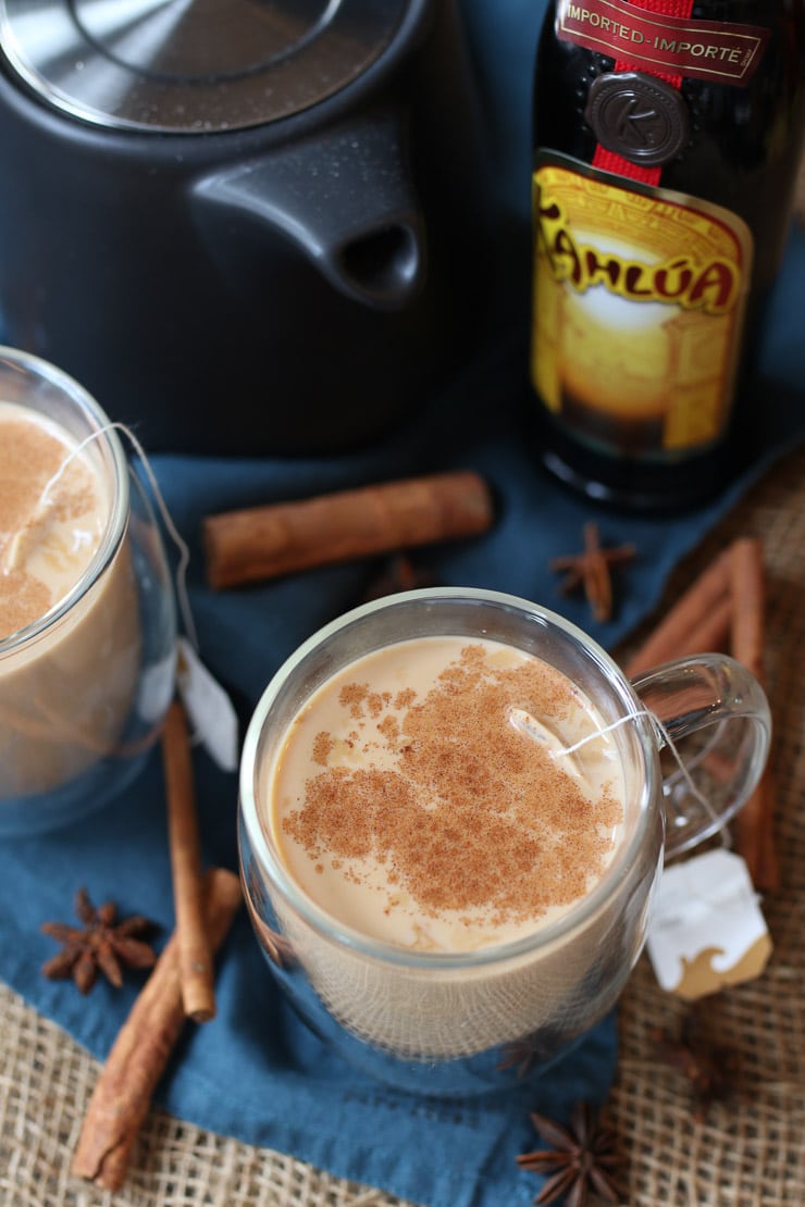birds eye view of dirty Chai tea cocktail in a glass mug topped with cinnamon for the holidays 