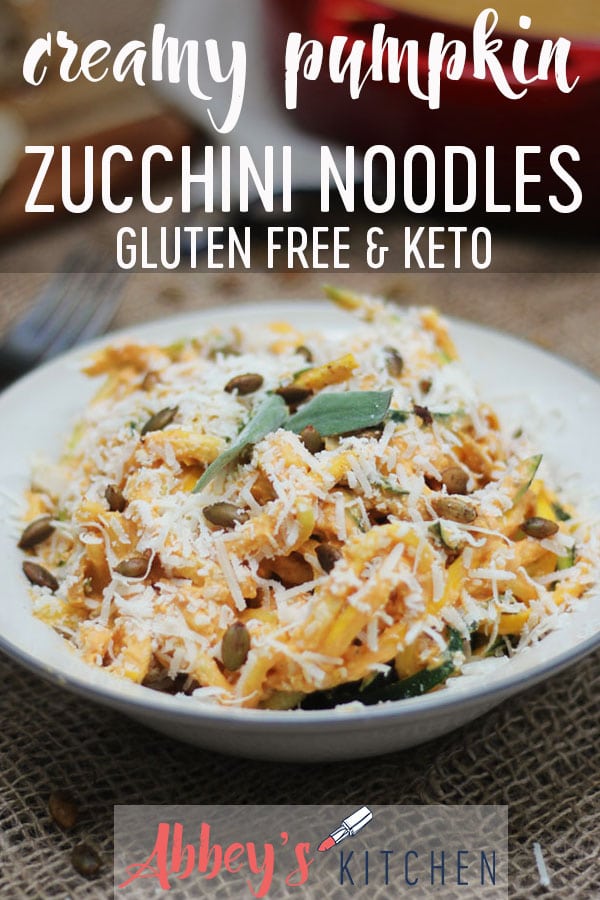 pinterest image of creamy gluten free and keto pumpkin zoodles topped with spiced pumpkin seeds in a white bowl with text overlay