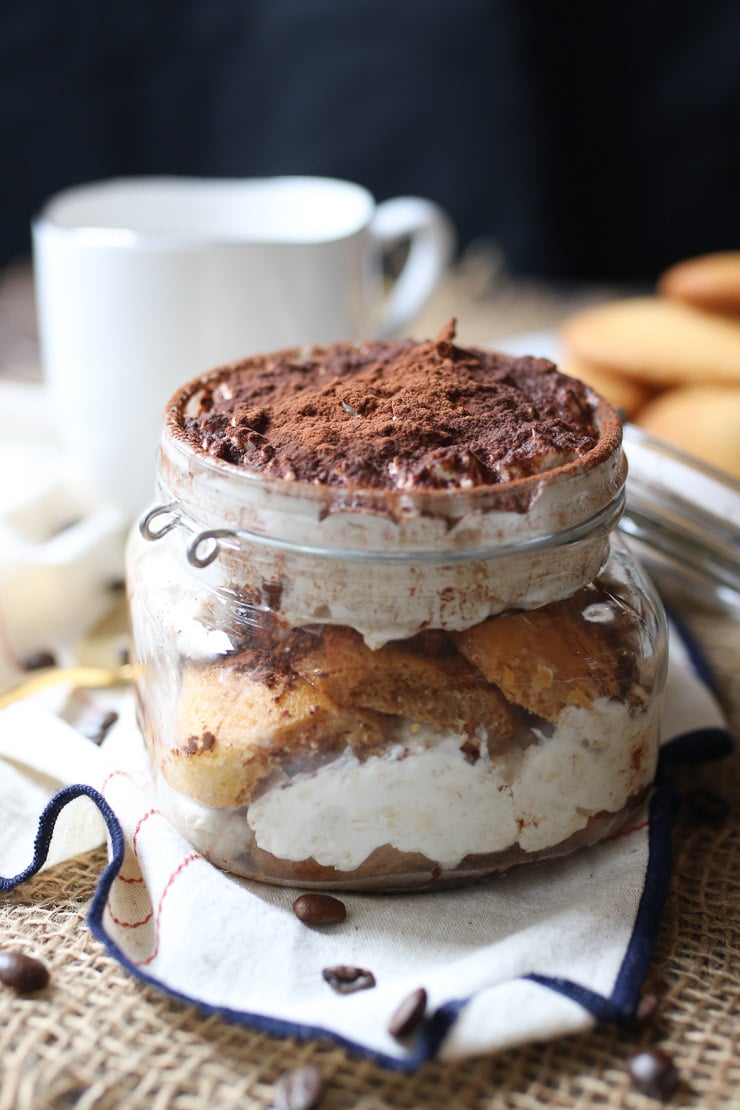 tiramisu protein oatmeal in a glass jar topped with cocoa powder